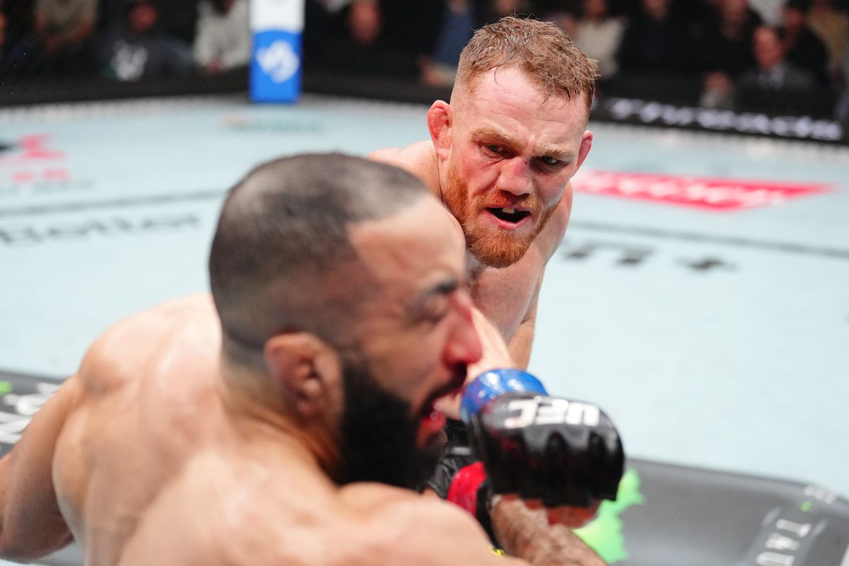 JDM celebrates victory over Belal Muhammad in the octagon.